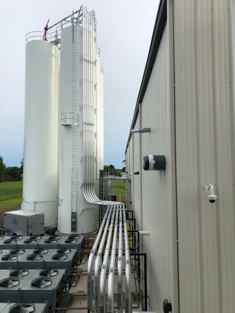 metal piping to white containers